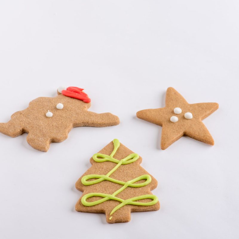 Iced gingerbread shapes: a gingerbread man, a star and a Christmas tree