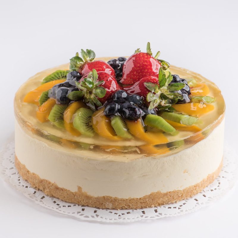 A mixed fruit cheesecake topped with glazed seasonal fruit